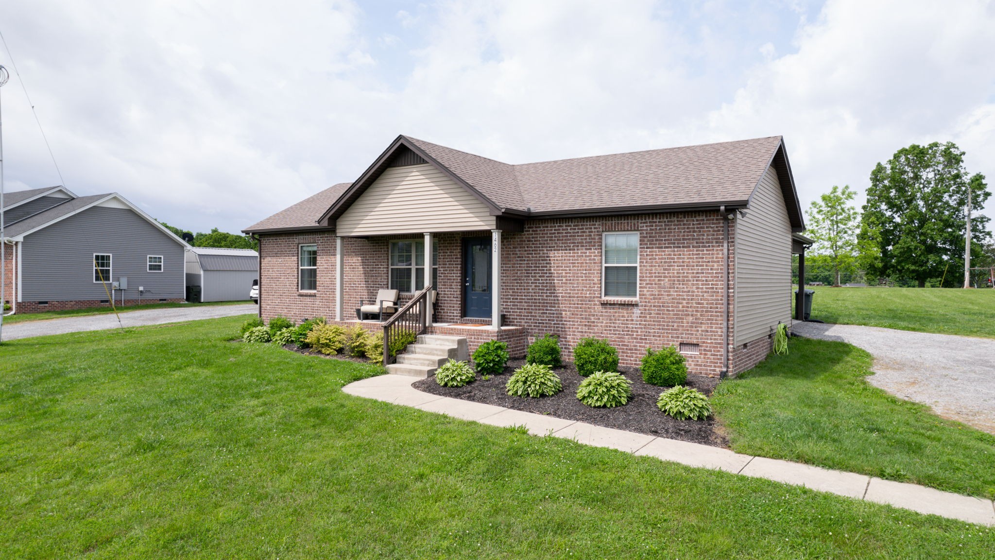 1462 East Ab Wade Road Portland, TN 37148 - Photo 42 of 52 a front view of a house with a garden and yard