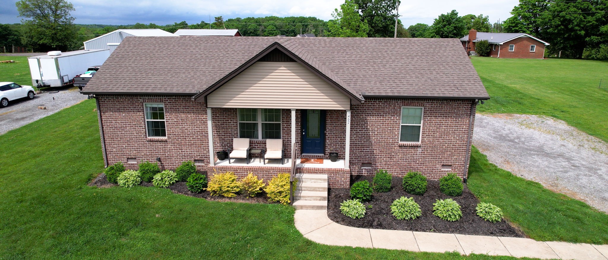 1462 East Ab Wade Road Portland, TN 37148 - Photo 47 of 52 a view of a house with a yard potted plants and a table