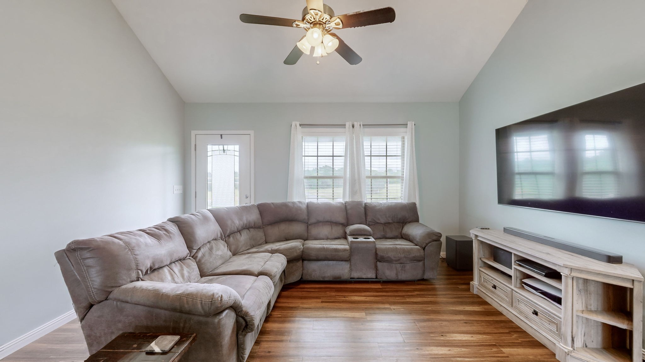 1462 East Ab Wade Road Portland, TN 37148 - Photo 9 of 52 a living room with furniture a flat screen tv and a window