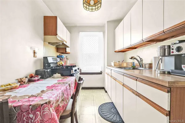 a kitchen with a sink appliances and cabinets