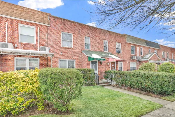 a view of a brick building next to a yard
