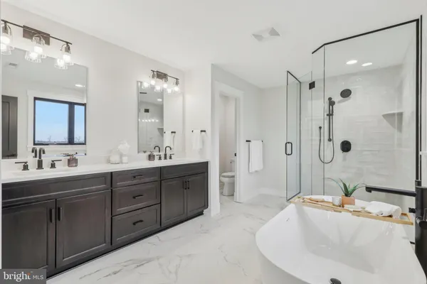 a white bath tub sitting next to a white sink