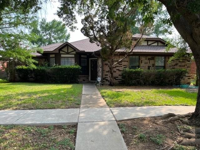 a front view of a house with a yard and a garage