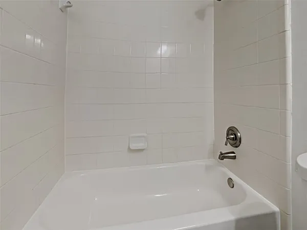 a view of an empty room with wooden floor and closet