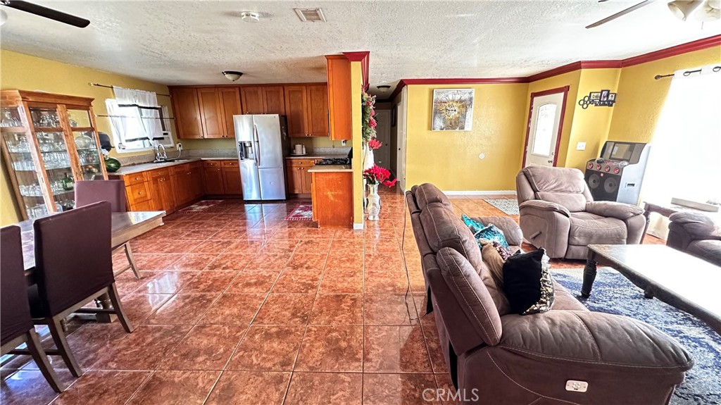 21290 Ellis Avenue Perris, CA 92570 - Photo 16 of 47 a living room with furniture kitchen area and a large window