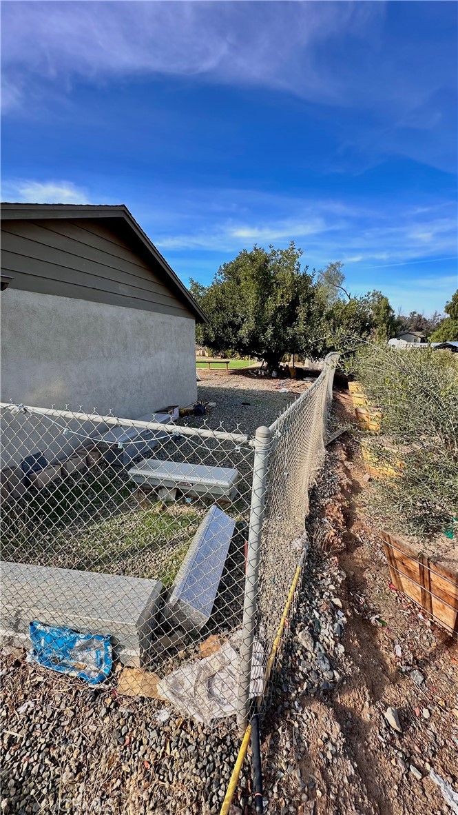 21290 Ellis Avenue Perris, CA 92570 - Photo 18 of 47 a view of a dry yard with wooden fence