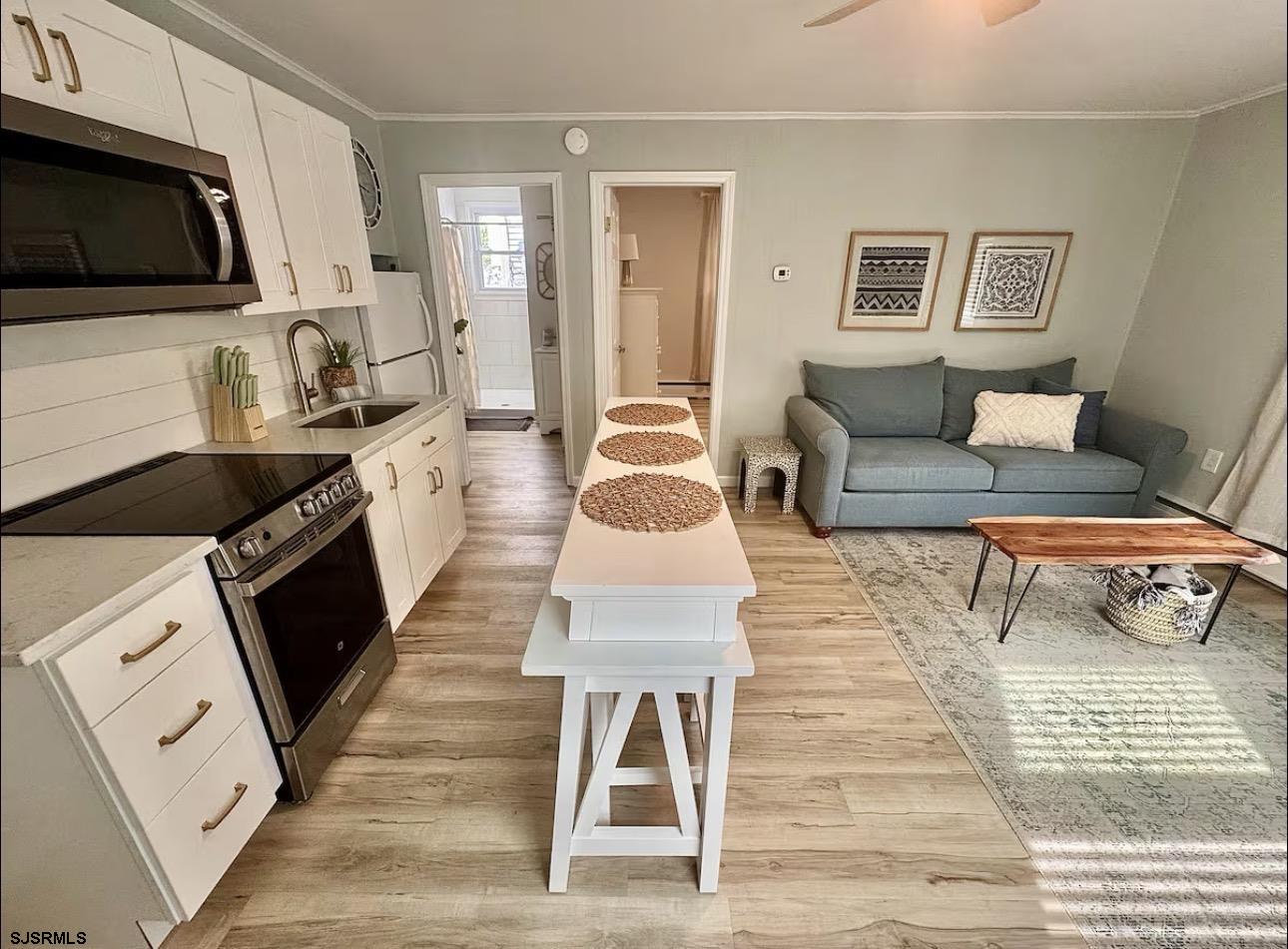 512 West Brigantine Avenue, Unit A Brigantine, NJ 08203 - Photo 11 of 26 a living room with furniture and a wooden floor