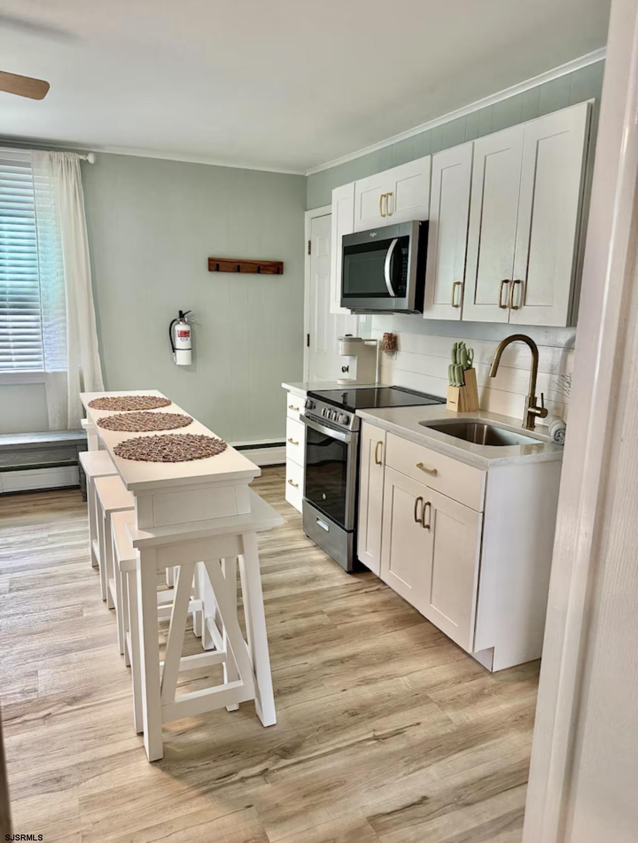 512 West Brigantine Avenue, Unit A Brigantine, NJ 08203 - Photo 13 of 26 a kitchen with a sink stove top oven and microwave