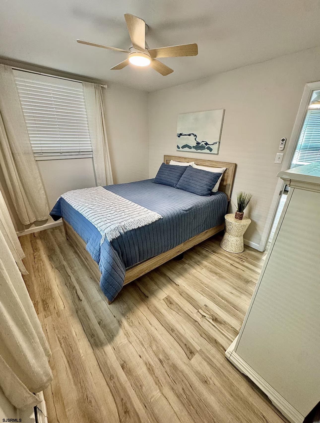 512 West Brigantine Avenue, Unit A Brigantine, NJ 08203 - Photo 18 of 26 a bedroom with a bed and wooden floor