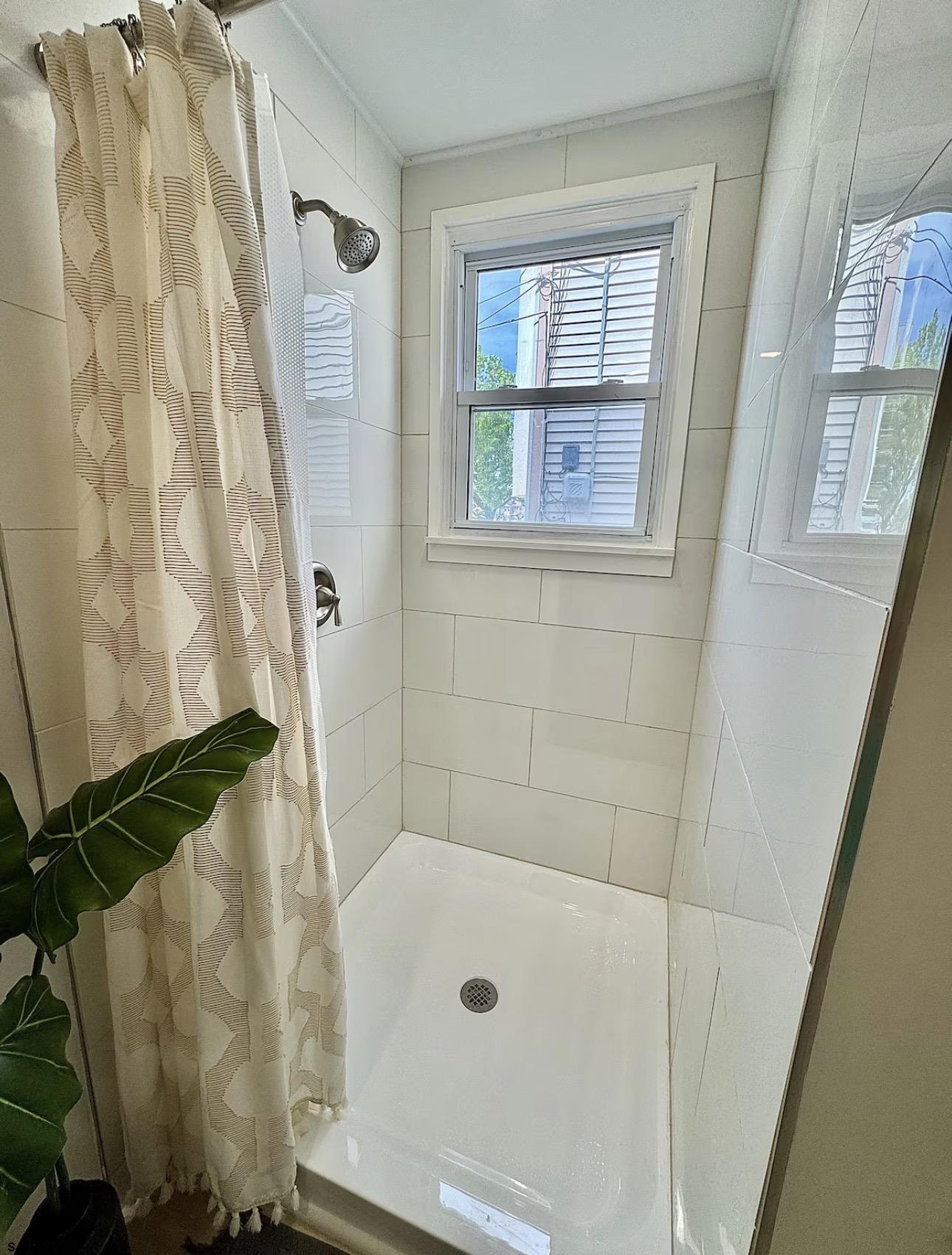 512 West Brigantine Avenue, Unit A Brigantine, NJ 08203 - Photo 19 of 26 a bathroom with a tub and a shower