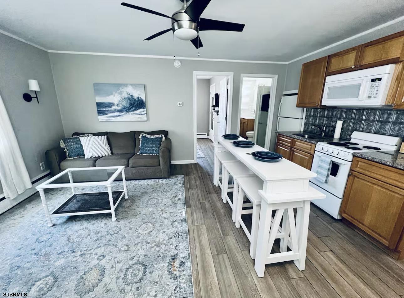 512 West Brigantine Avenue, Unit A Brigantine, NJ 08203 - Photo 2 of 26 a living room with furniture and a wooden floor