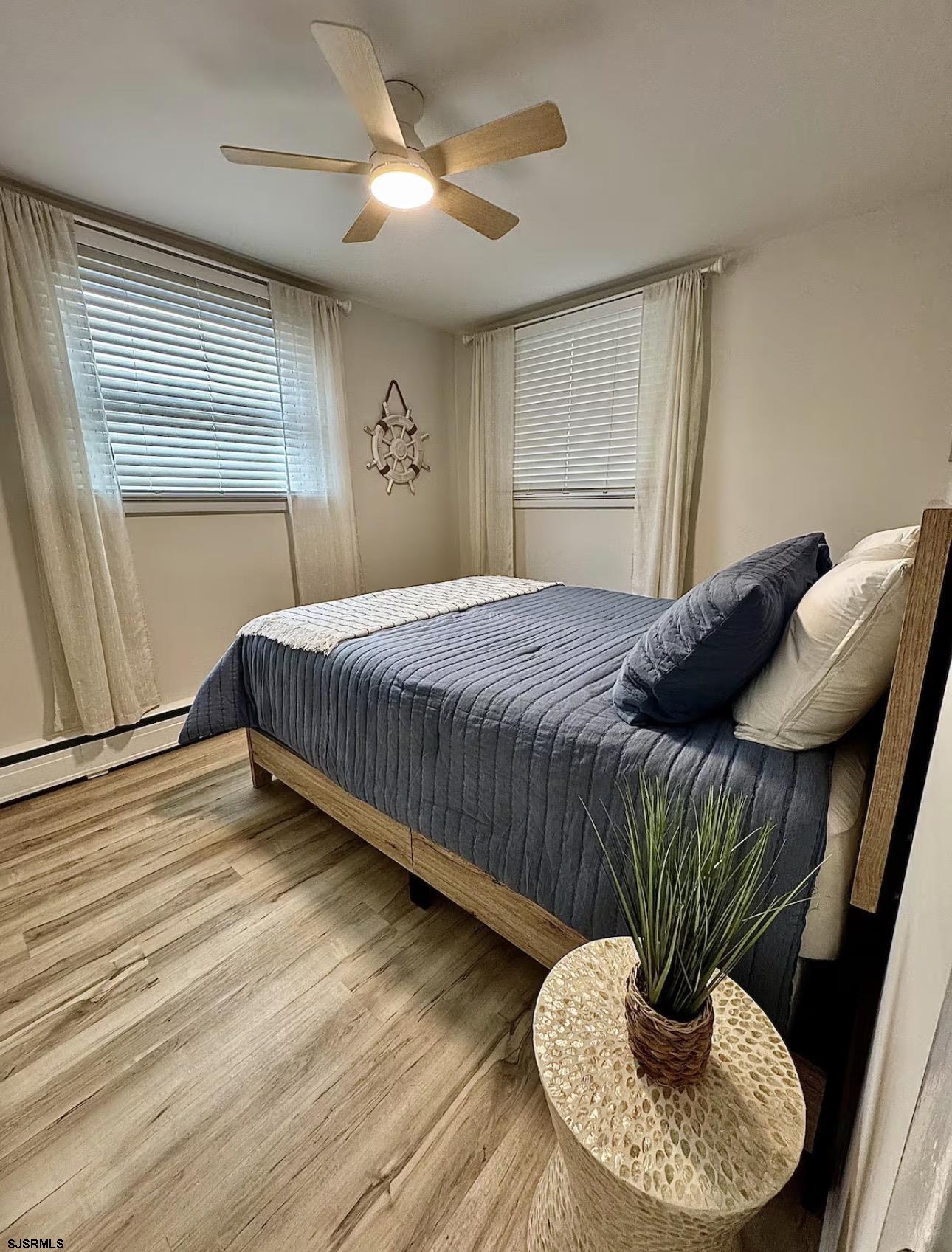 512 West Brigantine Avenue, Unit A Brigantine, NJ 08203 - Photo 21 of 26 a bedroom with a bed and a chandelier