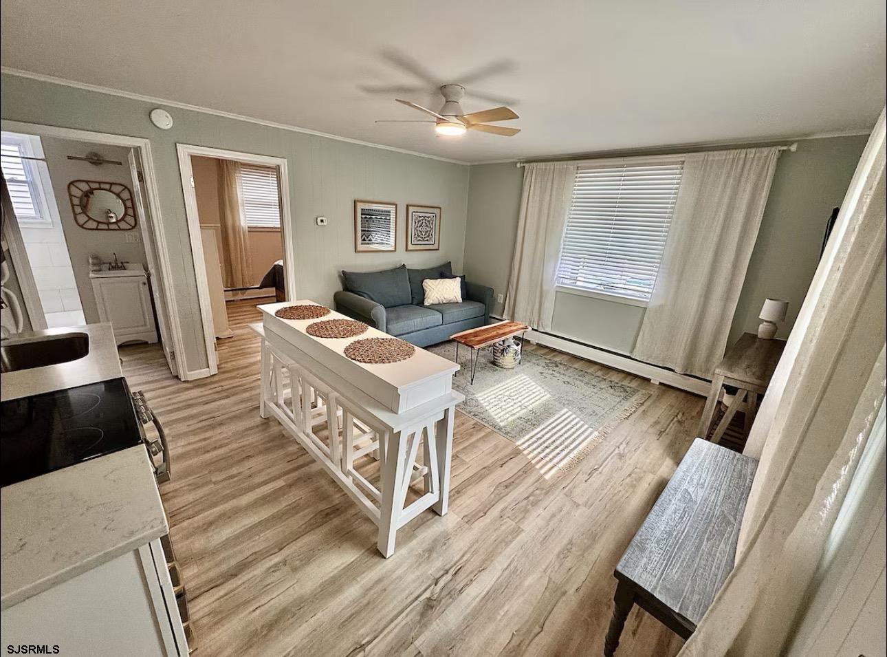 512 West Brigantine Avenue, Unit A Brigantine, NJ 08203 - Photo 8 of 26 a living room with a bed furniture and a large window
