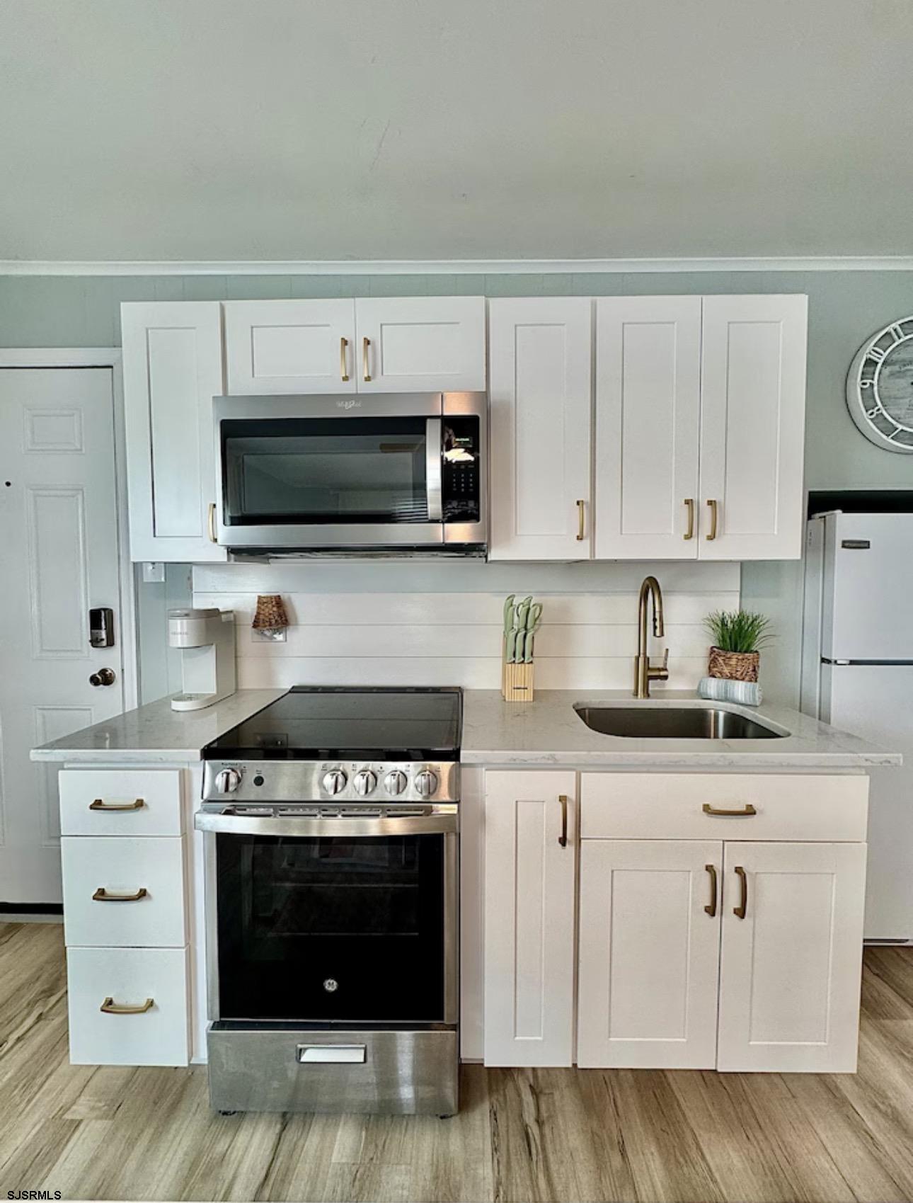 512 West Brigantine Avenue, Unit A Brigantine, NJ 08203 - Photo 9 of 26 a kitchen with white cabinets and appliances