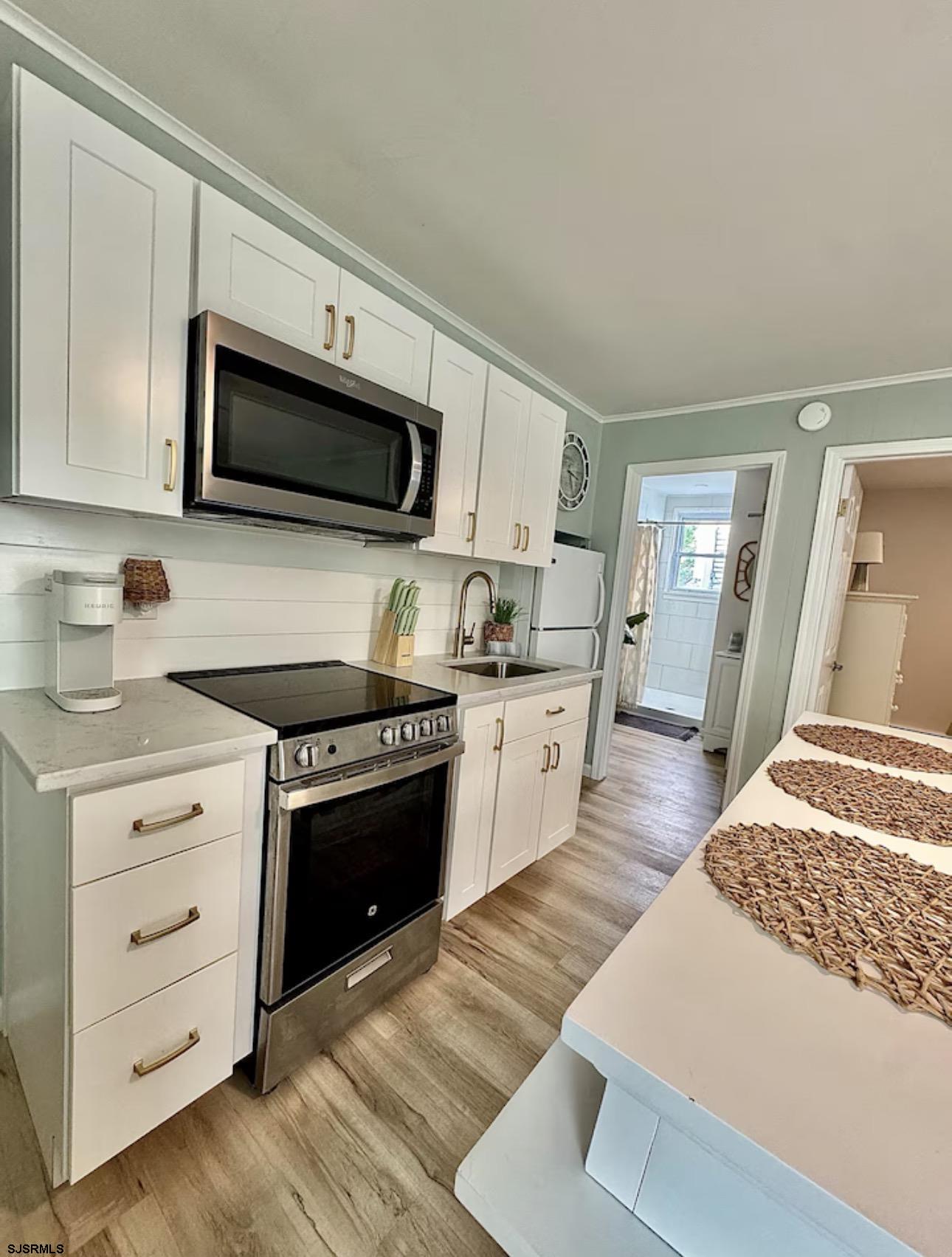 512 West Brigantine Avenue, Unit A Brigantine, NJ 08203 - Photo 10 of 26 a kitchen with stainless steel appliances granite countertop a stove and a microwave