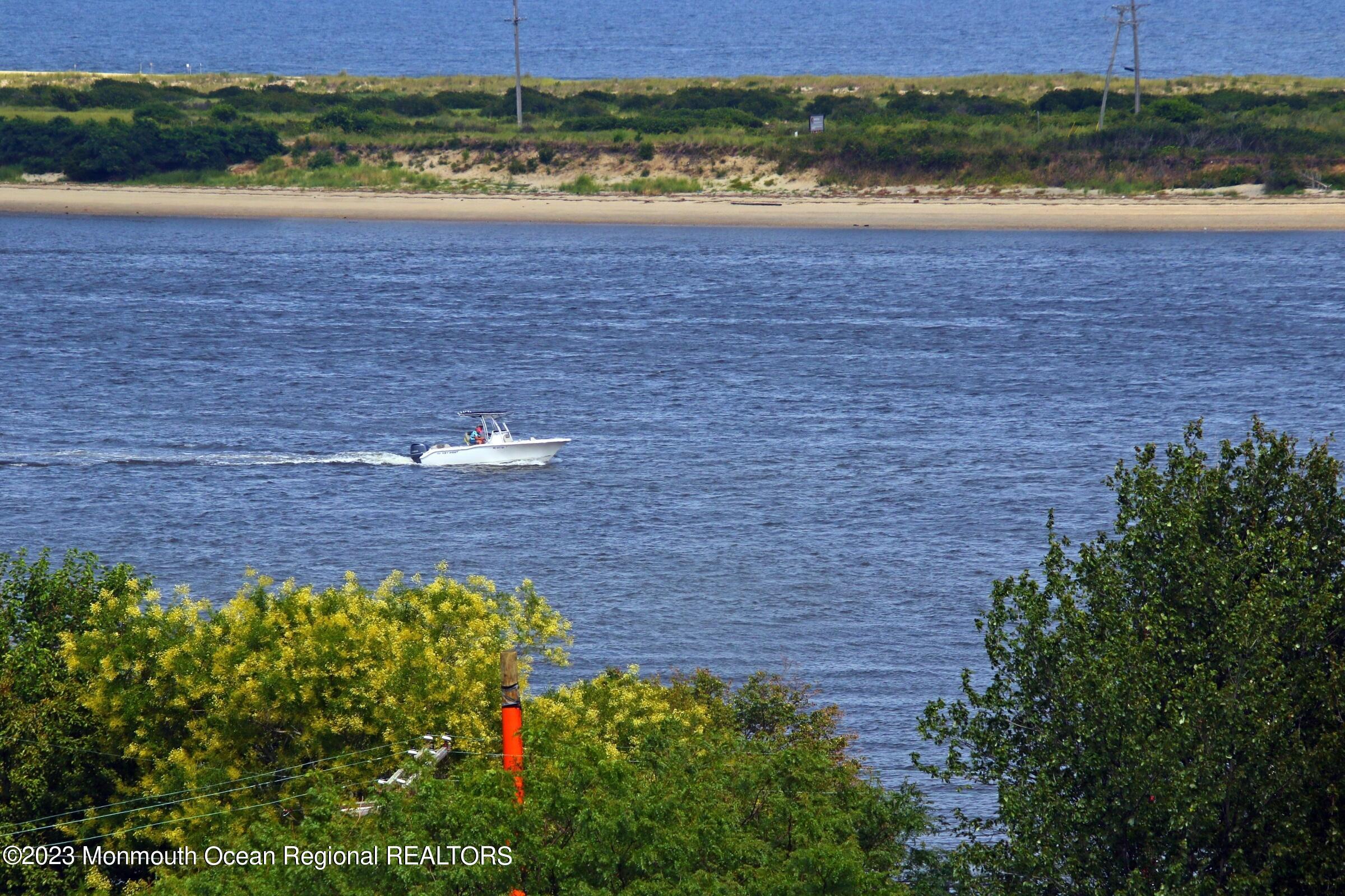 52 Navesink Avenue Highlands, NJ 07732 - Photo 13 of 71 a view of a bunch of trees and swimming pool