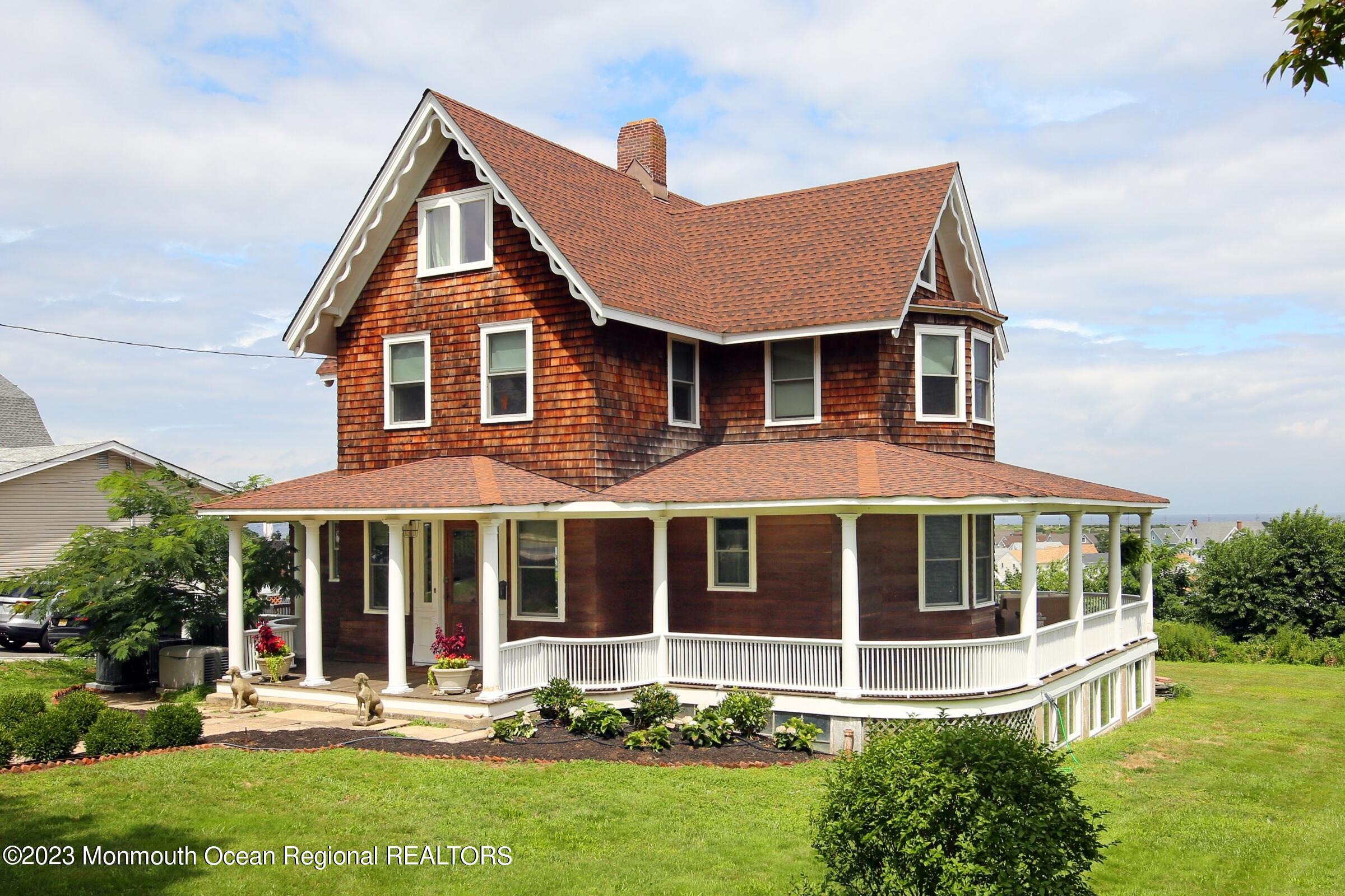 52 Navesink Avenue Highlands, NJ 07732 - Photo 17 of 71 a front view of a house with a yard table and chairs