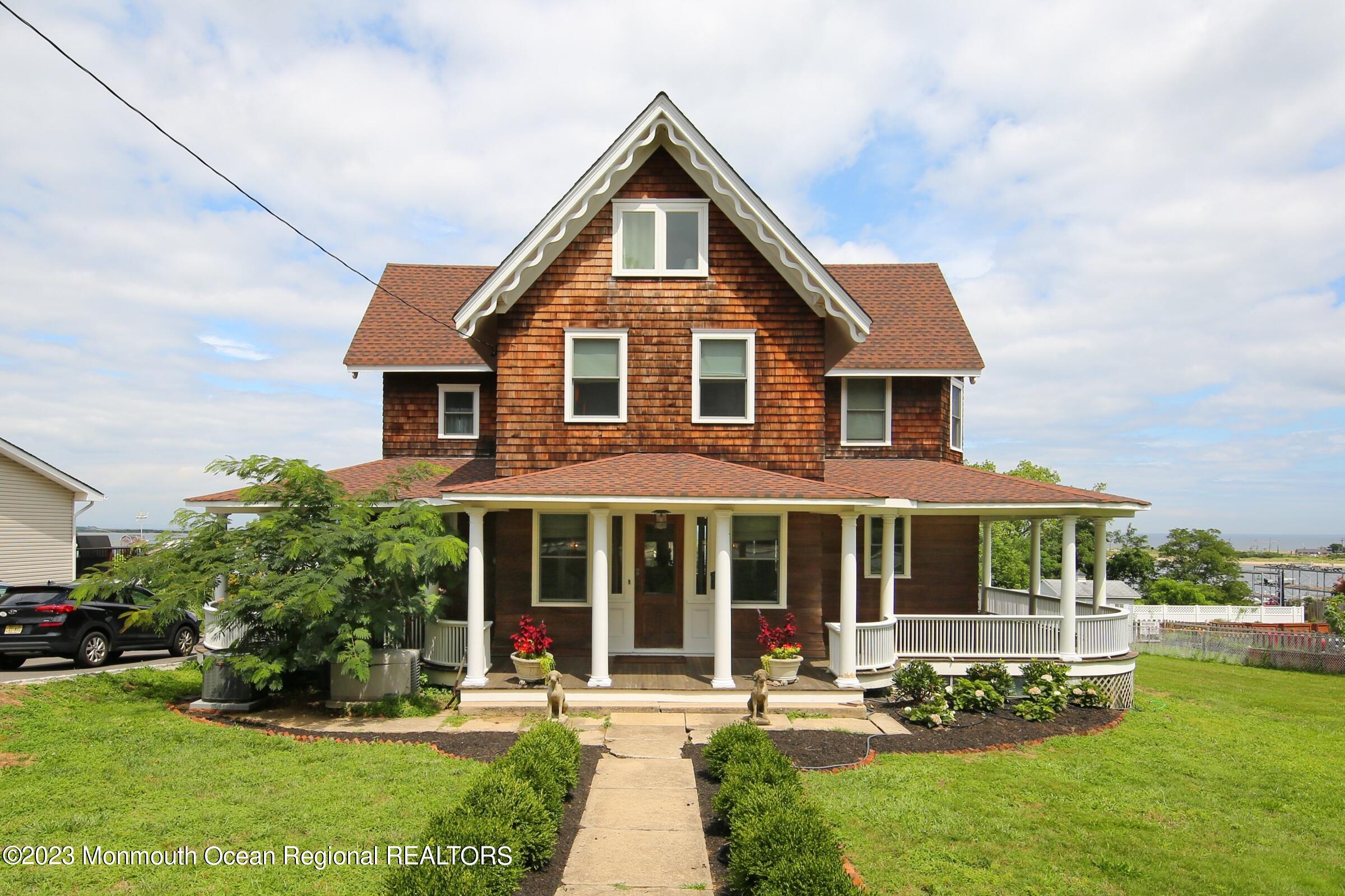 52 Navesink Avenue Highlands, NJ 07732 - Photo 2 of 71 a front view of a house with a yard table and chairs