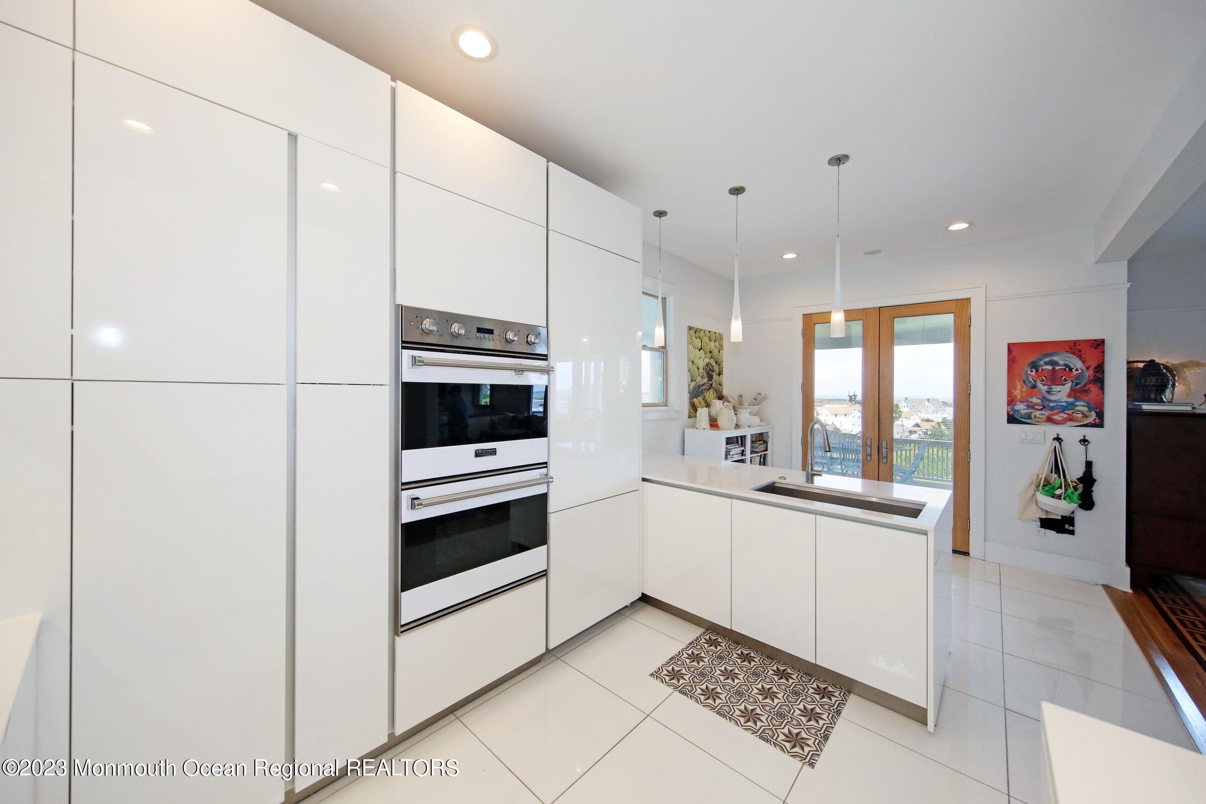 52 Navesink Avenue Highlands, NJ 07732 - Photo 35 of 71 a kitchen with stainless steel appliances a refrigerator and a stove top oven