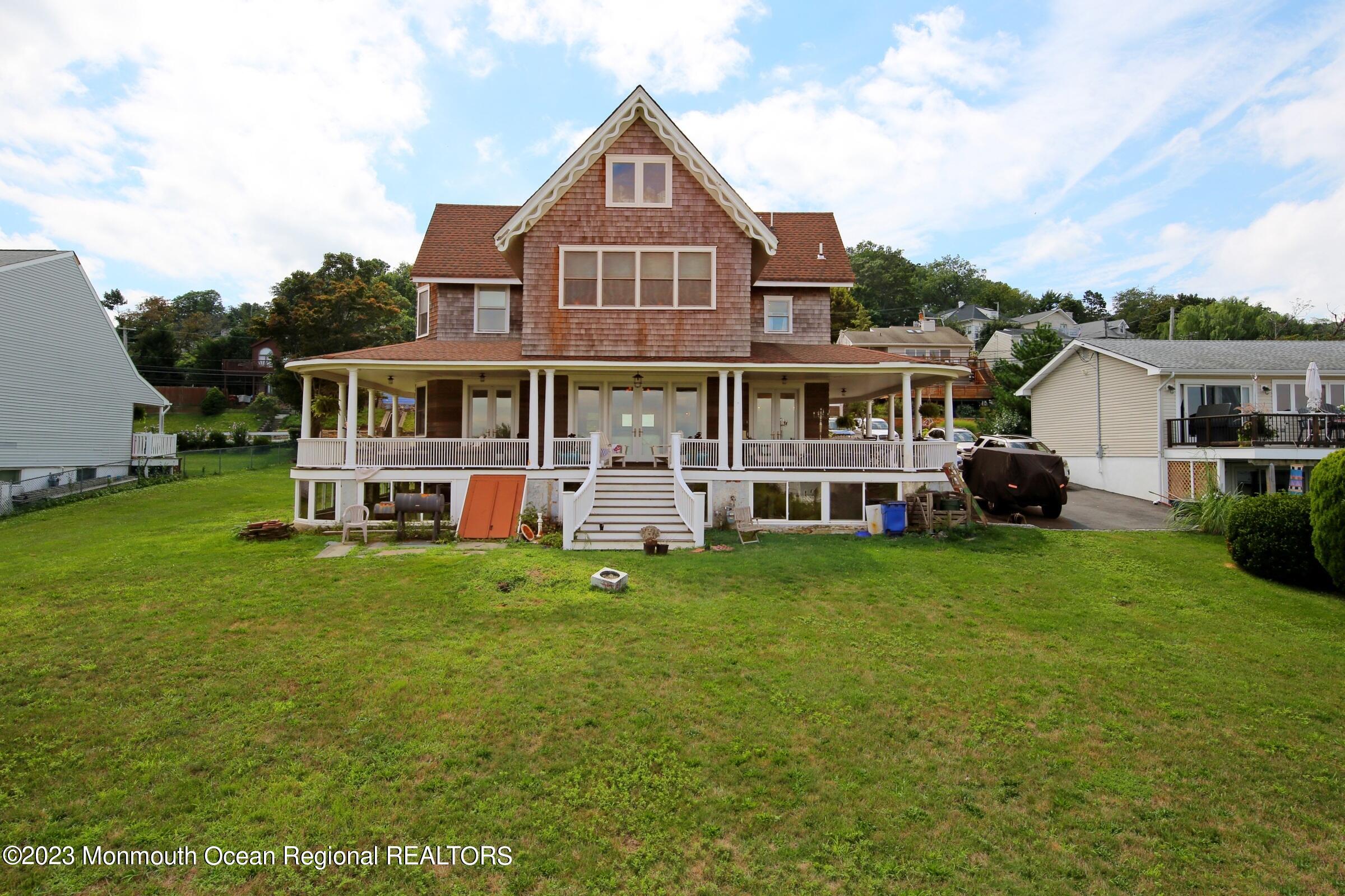 52 Navesink Avenue Highlands, NJ 07732 - Photo 36 of 71 a front view of a house with a yard table and chairs
