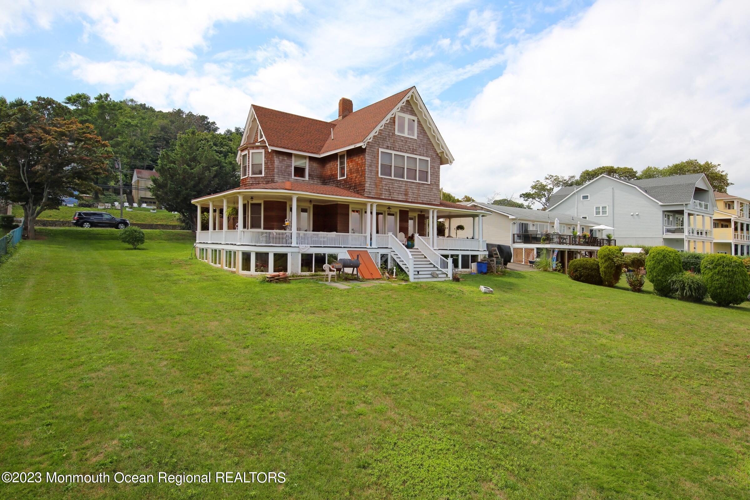 52 Navesink Avenue Highlands, NJ 07732 - Photo 39 of 71 a view of a house with a big yard and large trees