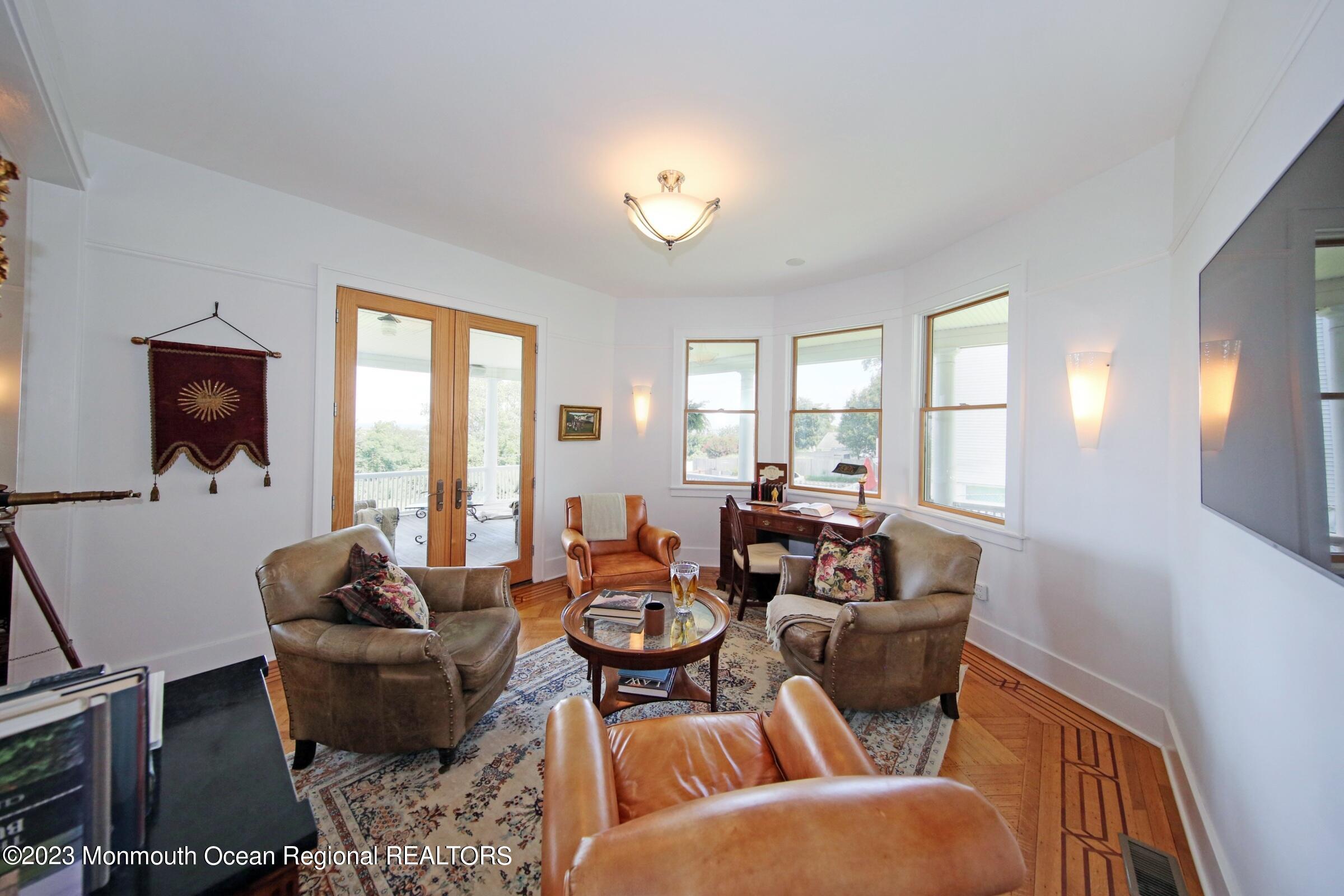 52 Navesink Avenue Highlands, NJ 07732 - Photo 50 of 71 a living room with furniture a large window and a flat screen tv