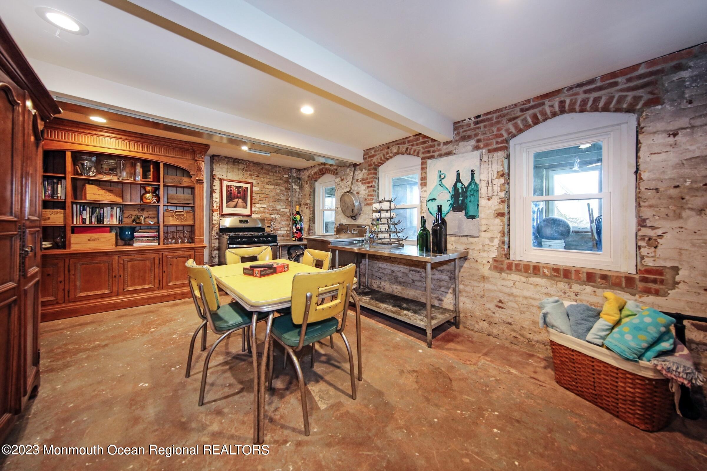 52 Navesink Avenue Highlands, NJ 07732 - Photo 53 of 71 a living room with furniture a bookshelf and kitchen view
