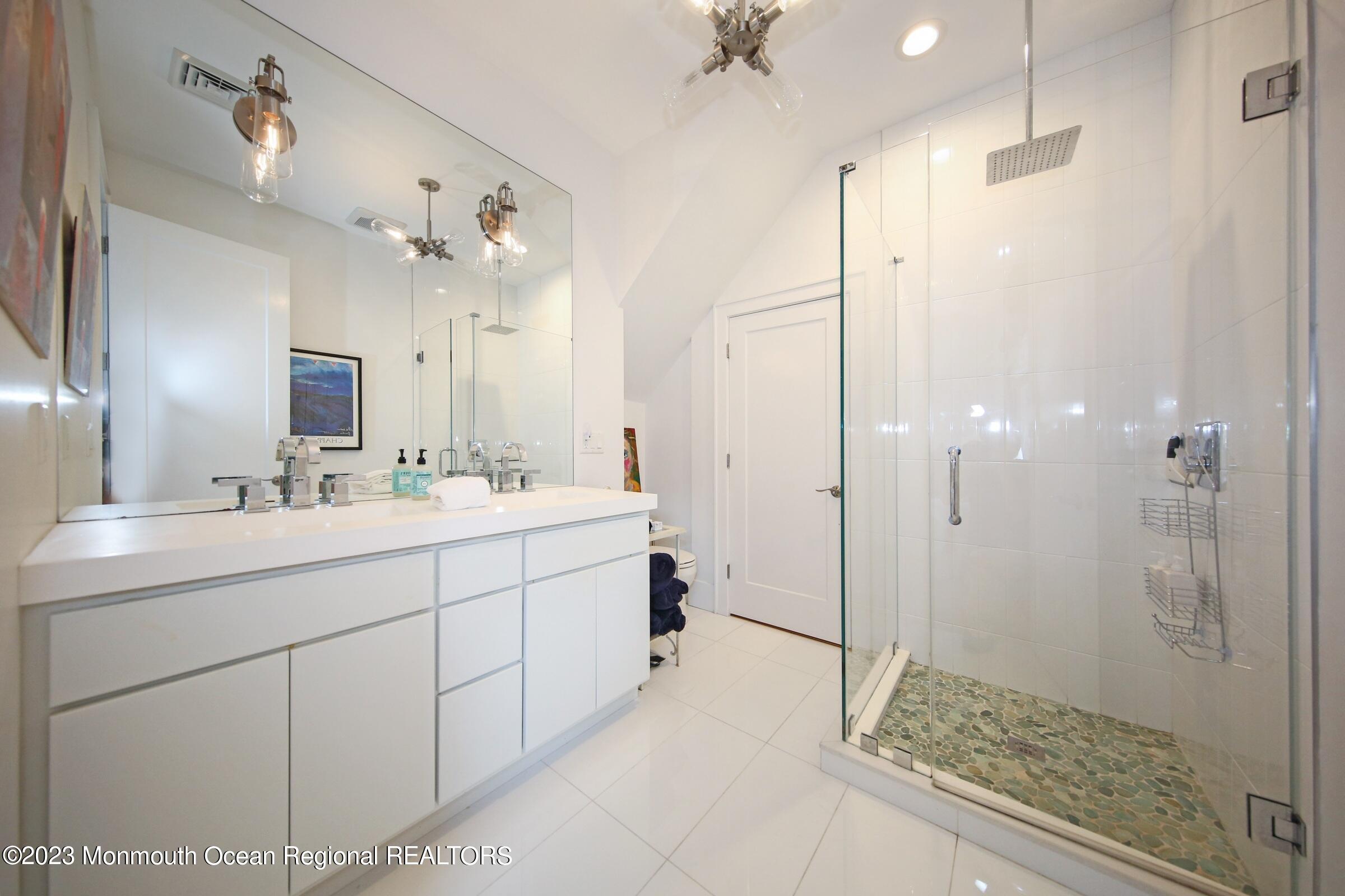 52 Navesink Avenue Highlands, NJ 07732 - Photo 54 of 71 a bathroom with a double vanity sink mirror and shower