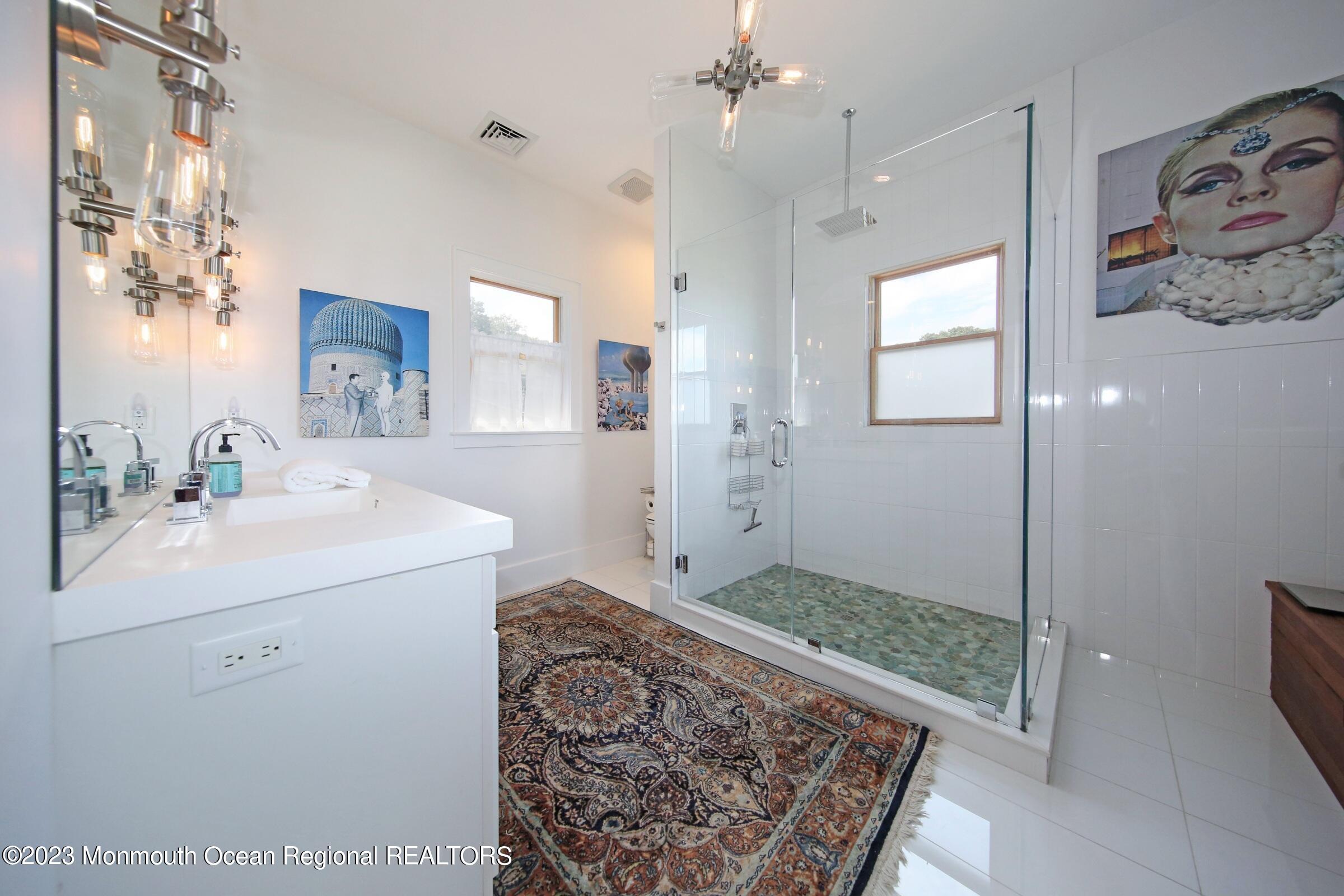 52 Navesink Avenue Highlands, NJ 07732 - Photo 63 of 71 a spacious bathroom with a sink a mirror a vanity and a shower