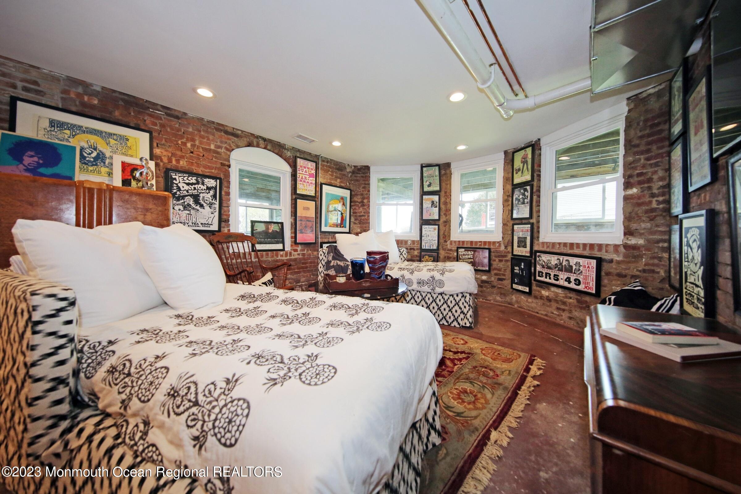 52 Navesink Avenue Highlands, NJ 07732 - Photo 67 of 71 a bed room with a bed a couch and a flat tv screen