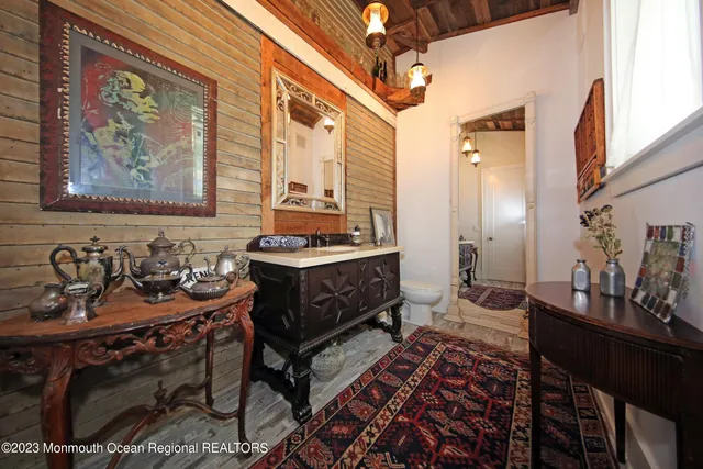 a living room with furniture large window and wooden floor