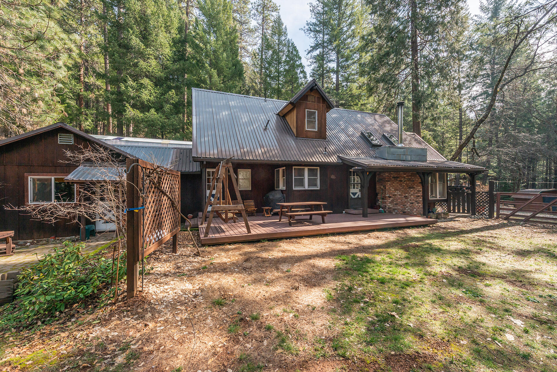 491 East Branch Road Weaverville, CA 96093 - Photo 18 of 59 a front view of a house with a yard table and chairs