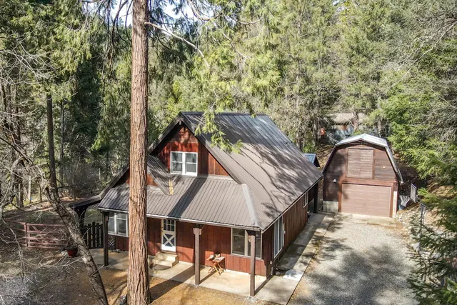 a aerial view of a house with a yard and balcony