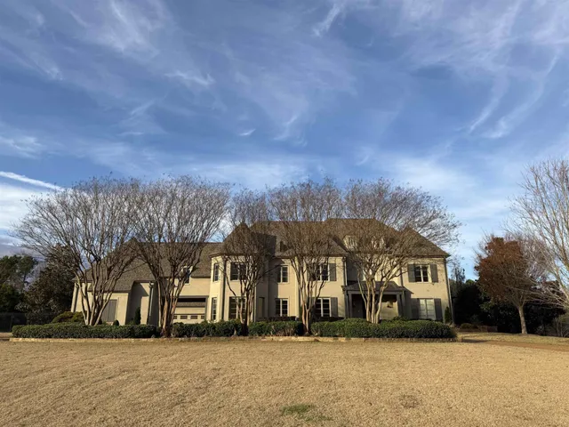 a front view of a residential apartment building with a yard
