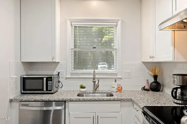 a living room with furniture and a mirror