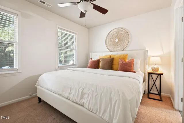 a bathroom with a bathtub shower sink mirror and toilet
