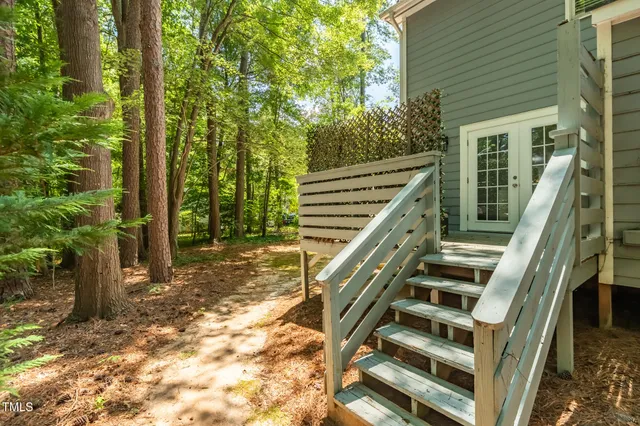 a view of a house with a tree and a forest