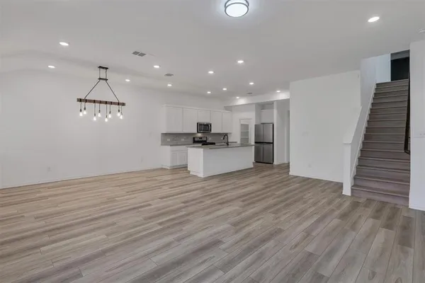 a view of kitchen with cabinets and wooden floor