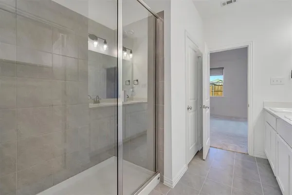 a bathroom with a shower and a sink