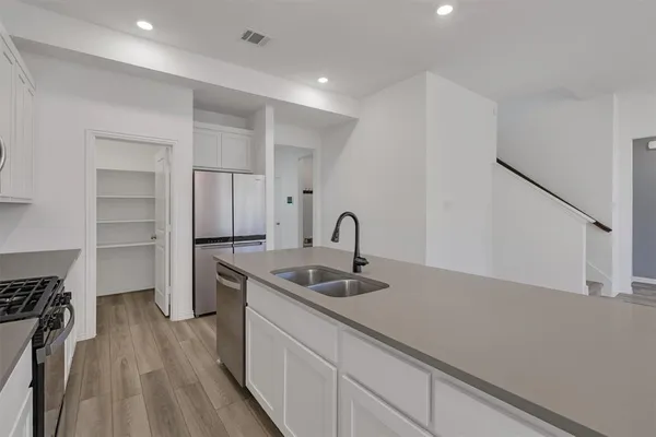 a kitchen with a sink and cabinets