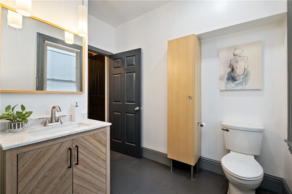 162 Almond Way Pittsburgh, PA 15201 - Photo 17 of 38 a bathroom with a granite countertop toilet sink and mirror