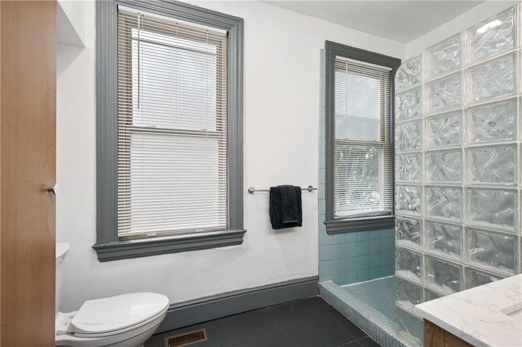 162 Almond Way Pittsburgh, PA 15201 - Photo 19 of 38 a bathroom with a toilet sink vanity and mirror