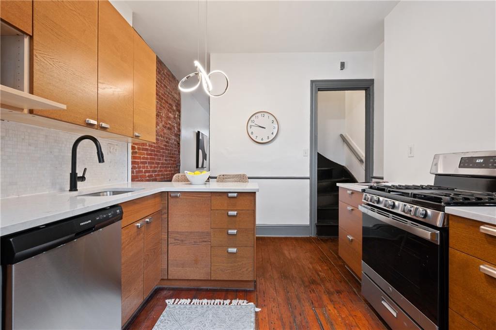 162 Almond Way Pittsburgh, PA 15201 - Photo 7 of 38 a kitchen with stainless steel appliances granite countertop a stove a sink and a wooden floors