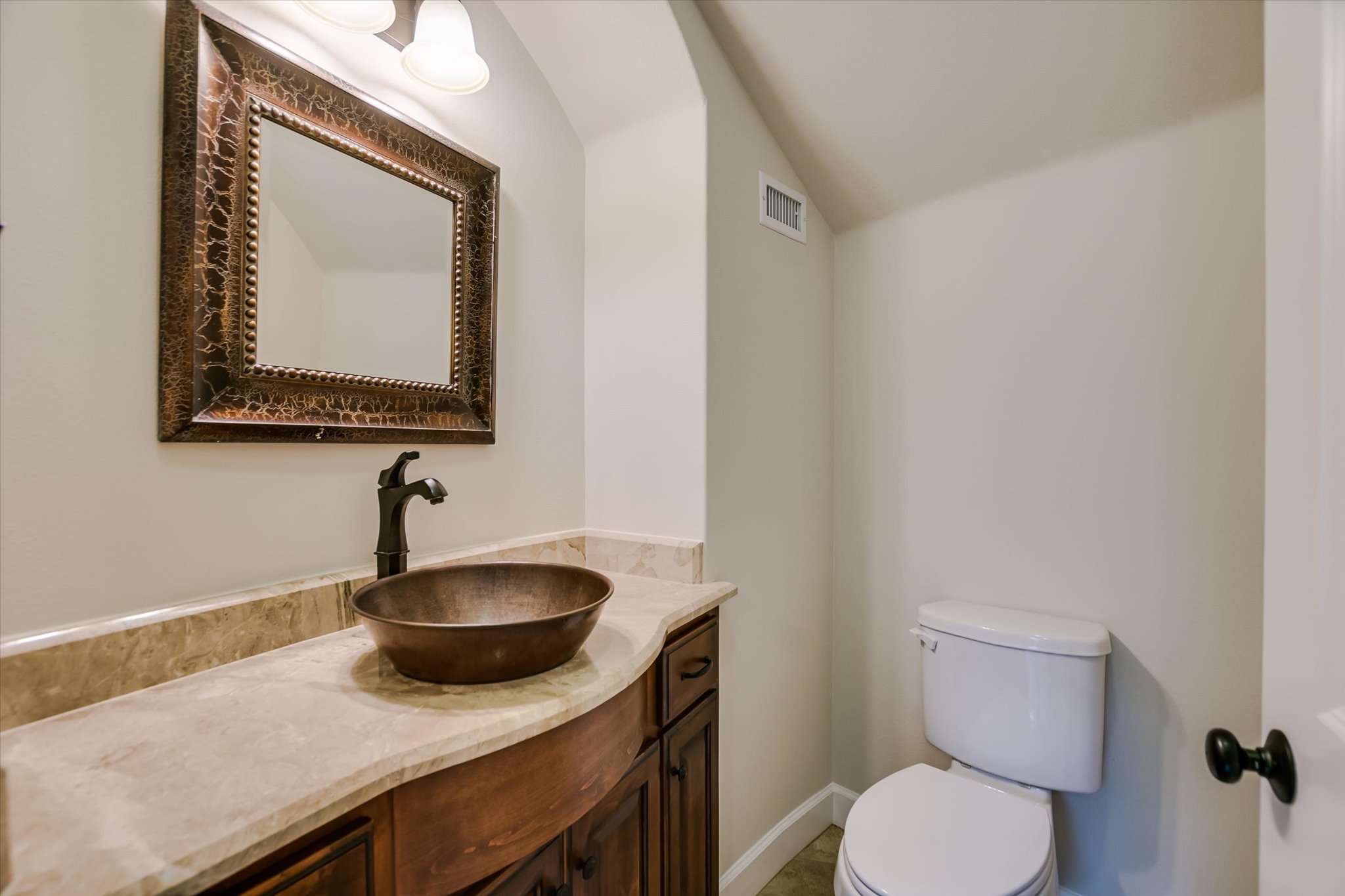 11 Inwood Circle Austin, TX 78746 - Photo 9 of 38 Elegant powder room featuring a copper vessel sink and rich wood vanity.
