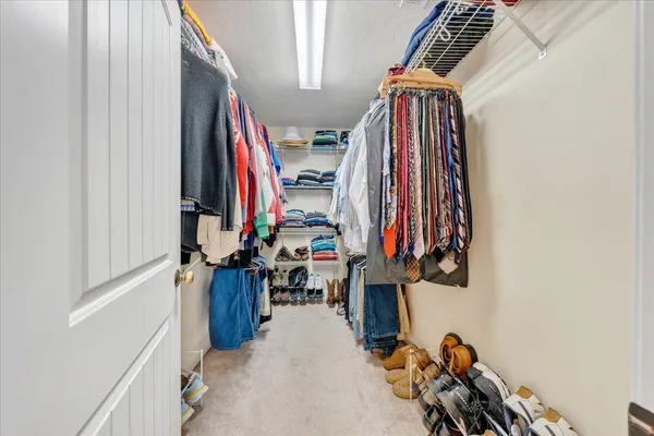 a bed room with a bed and a chair