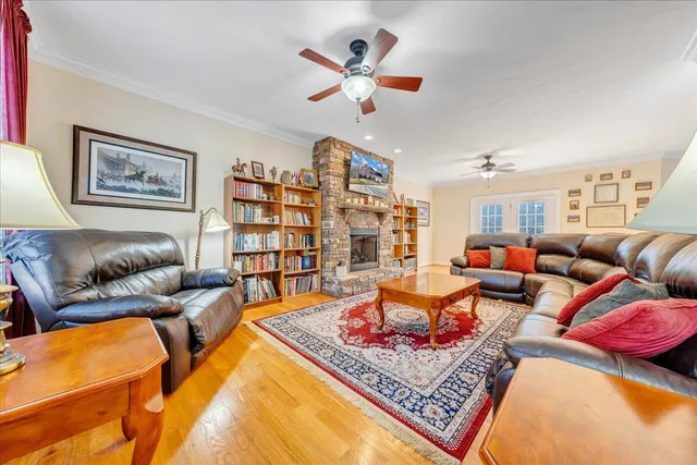 a living room with furniture and a book shelf