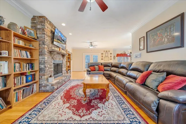 a living room with furniture a fireplace and a chandelier