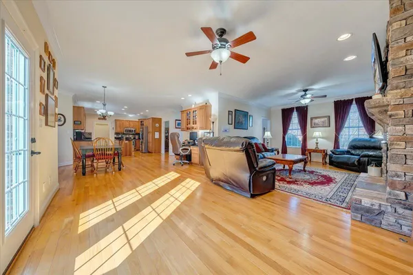 a living room with furniture and a wooden floor