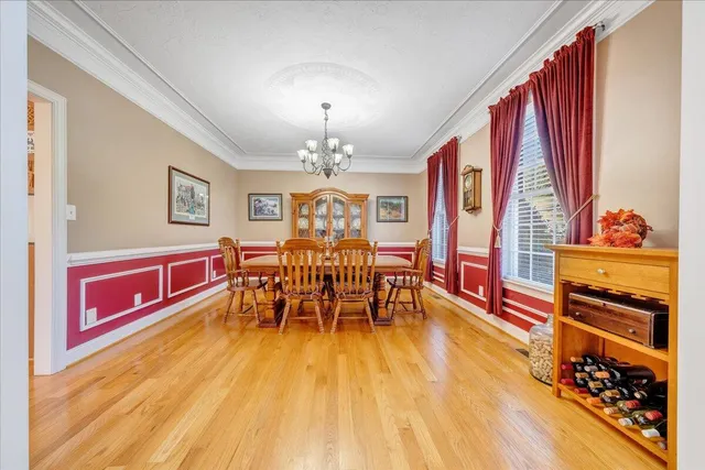 a dining room with furniture and wooden floor