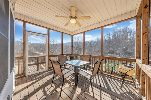 a view of a dining room with furniture large windows and wooden floor